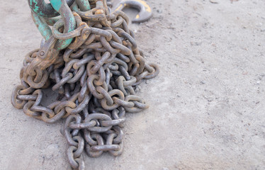 a large metal old chain lies on the ground
