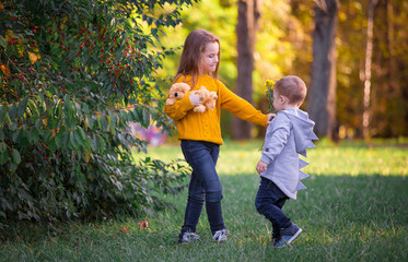 Fototapeta premium Boy and girl, autumn landscape