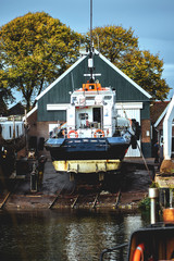 Obraz premium an old boat is undergoing scheduled maintenance at a port on one of the many canals in the Netherlands