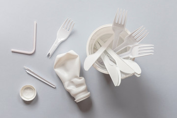 Used white plastic for food on a gray background