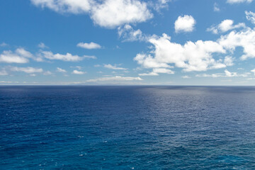 Wide, peaceful, blue ocean landscape under a sunny blue sky with white clouds, Oahu, Hawaii, USA © Eric Dale Creative
