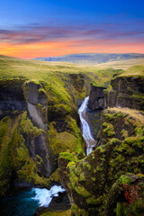 Amazing nature of Iceland. Impressive view on picturesque canyon Fjadrargljufur with colorful sky...