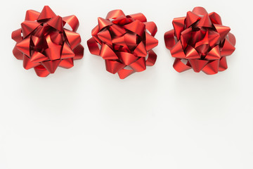 Red ribbon bows over white background. Birthday, Christmas or Valentine's day mock up frame or border.