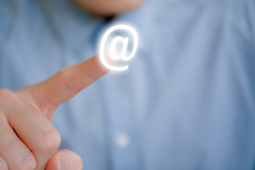 A male finger points to an email icon. The concept of the appeal to send a letter.