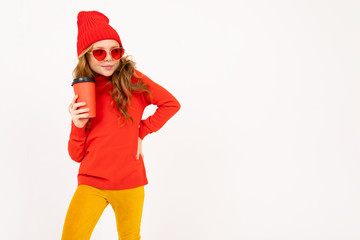 girl in a red hat and glamour sunglasses with a glass in hand on a white background