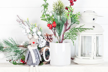 Mug mockup with fir branches, cones and Christmas lantern