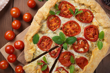  Homemade pizza with cheese and tomatoes.