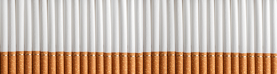 background a lot of cigarettes with filter in a row, close-up