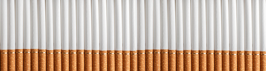 background a lot of cigarettes with filter in a row, close-up