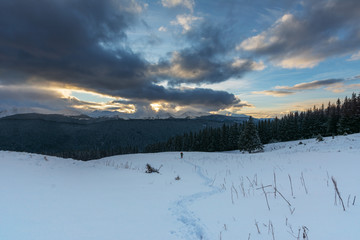 Colorful winter dawn on the mountain valleys in the Ukrainian Carpathian Mountains.	