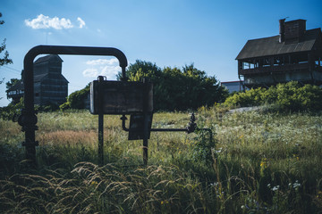 abandoned and destroyed industrial building at summer countryside