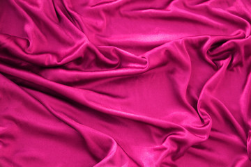 beautiful silk fabric of delicate pink color draped with small folds, soft flowing, luxurious, wedding concept, texture, background, form for a card, copy space