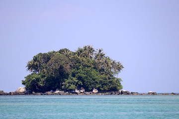 Tropical island with coconut palm trees in a ocean, picturesque view the calm water. Colorful seascape, concept of vacation and paradise nature