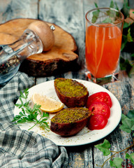 fried cotletes with green and tomato slices