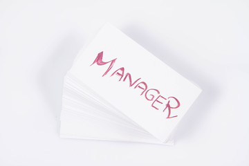 Stack of business cards with 'Manager' handwritten on the top one