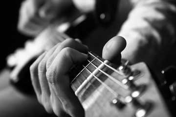 Black and white photo of man with guitar, closeup