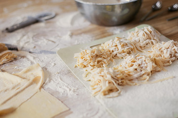 cooking  with a noodle slicer dough for pasta uncooked noodles