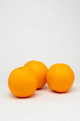 three fresh oranges on the table