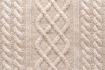 Beige Knitwear Fabric Texture with Pigtails. Beige Knitted Background.