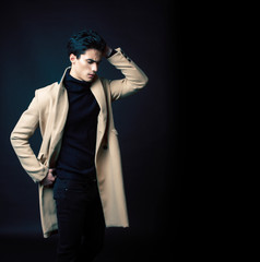 handsome asian fashion looking man posing in studio on black background, lifestyle modern people concept