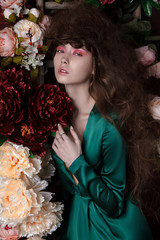 fashion studio portrait of a girl with flowers - 306029147