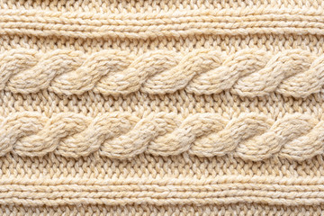 Beige Knitwear Fabric Texture with Pigtails. Beige Knitted Background.