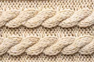 Beige Knitwear Fabric Texture with Pigtails. Beige Knitted Background.