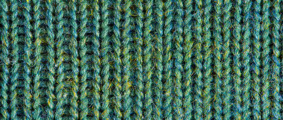 Green knitting wool texture. Cloth background close up