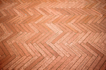 Orange bricks tiled floor with zigzag pattern texture background.