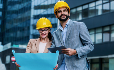 Construction engineers checking building site. Construction concept