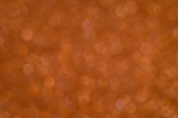 Abstract New Year coral bokeh background with shining defocus sparkles. Blurred glitters shimmering dust macro close up, copy space for text logo