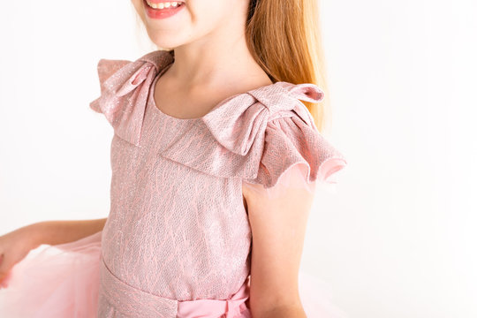 Beautiful little princess dancing in luxury pink dress