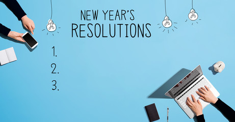 New years resolution with people working together with laptop and phone