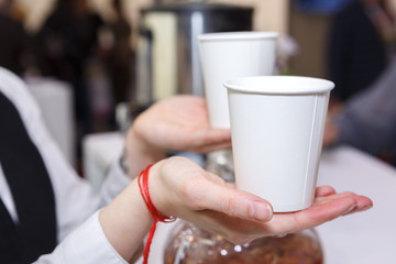 Two paper cups in hand