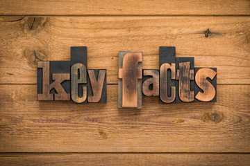 Key facts, phrase written with vintage letterpress printing blocks on rustic wood background