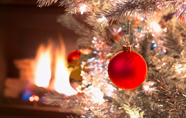Obraz na płótnie Canvas Growing Red Christmas Ornament handing in silver tree