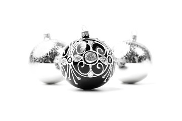 Trendy Christmas silver and black balls decor on isolated white background. Christmas backdrop for your design. Close-up.