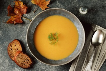 Autumn cream soup made from organic vegetables - pumpkin, sweet potato, carrot and turnip.