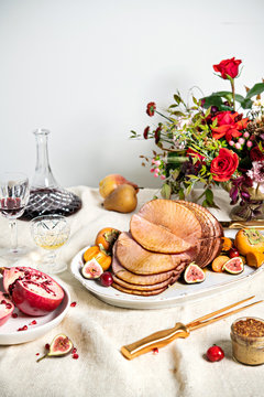 Holiday table setting with a baked ham