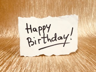 Happy birthday card with lettering on glitter gold background