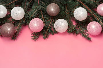 Close up of decorated Christmas tree branches with white, pink and taupe tree ornaments of baubles...