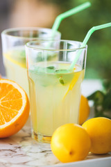 Glasses of fresh lemonade on table