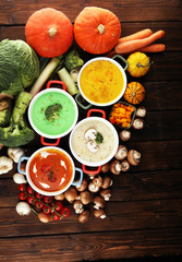 Variety of colorful vegetables cream soups and ingredients for soup. Concept of healthy eating or vegetarian food with mushrooms