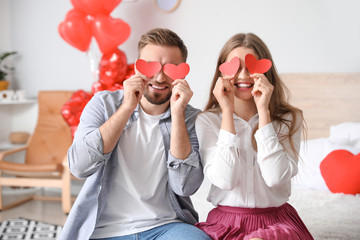 Happy young couple celebrating Valentine's Day at home