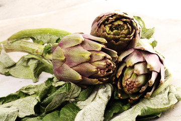 Obraz premium artichokes on grey background. fresh raw organic artichoke flower.