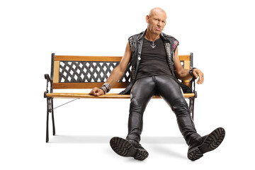 Bored grumpy ppunker sitting on a bench