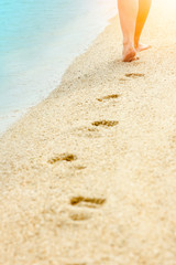 beautiful footprints in the sand by the sea background