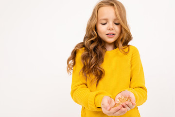 European girl holding a handful of glass crystals similar to lenses in her hand on a white background