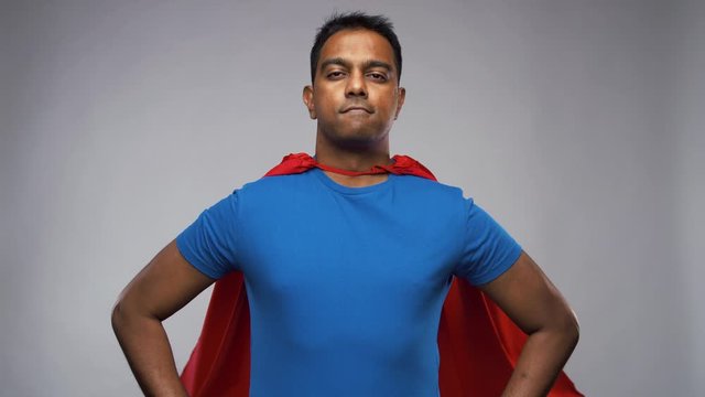 super power and people concept - happy smiling indian man in red superhero cape with crossed arms over grey background