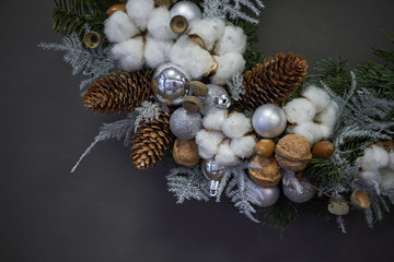 Fototapeta na wymiar Detail closeup Christmas wreath of vines decorated with fir branches, Christmas balls and natural materials, New Year concept